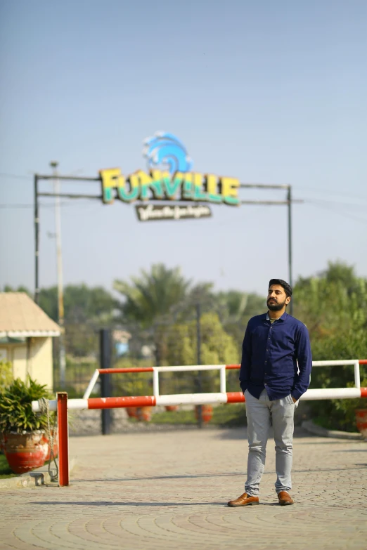 a man standing in front of a gate, falvie, water park, standing in road, profile image