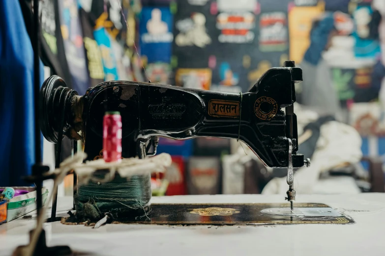 a sewing machine sitting on top of a table, a silk screen, by Nick Fudge, pexels contest winner, lyco art, tattoo parlor photo, wide screenshot, view from the side, sydney hanson