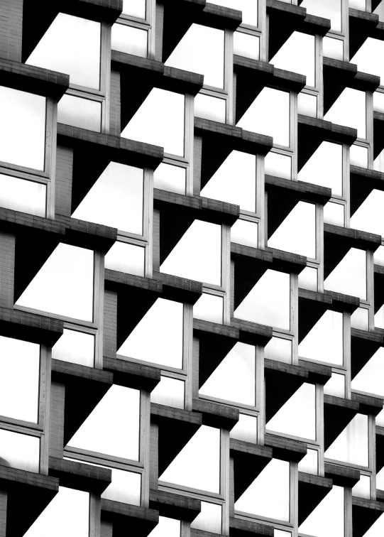 a black and white photo of a building, inspired by Ned M. Seidler, unsplash, brutalism, repeating pattern, square shapes, crenellated balconies, window ( city )