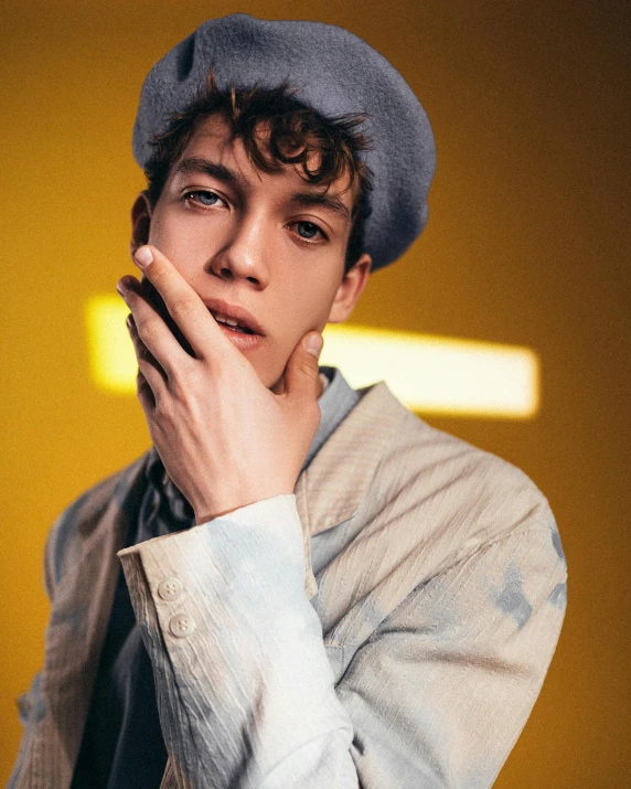 a close up of a person with a hat on, an album cover, inspired by Michelangelo Unterberger, trending on pexels, de stijl, he looks like tye sheridan, model posing, twink, glowy light