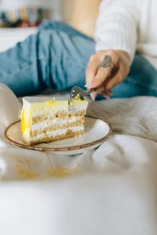 a person sitting on a bed eating a piece of cake, a pastel, by Andries Stock, trending on pexels, with yellow cloths, linen, delicious food, layer upon layer