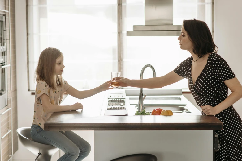 a woman standing next to a little girl in a kitchen, pexels contest winner, renaissance, drinking alcohol, sleek hands, sitting on the table, minimal kitchen