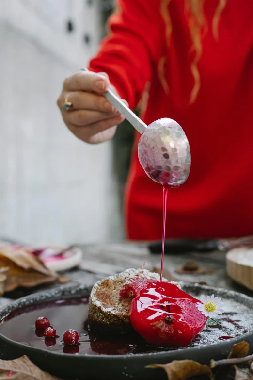 a person pouring syrup onto a piece of cake, inspired by Daniël Mijtens, wearing a red gilet, spoon placed, holiday season, magenta