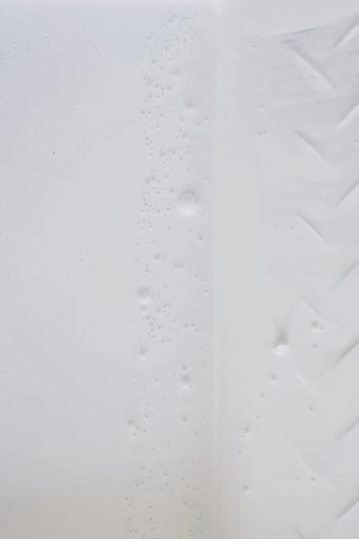 a white bath tub sitting inside of a bathroom, an ultrafine detailed painting, inspired by Lucio Fontana, unsplash, conceptual art, closeup of sweating forehead, embossed, 2011, white limbo