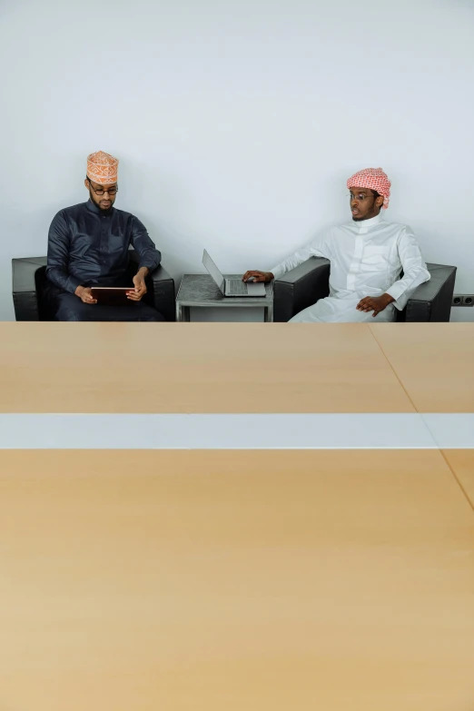 two men sitting next to each other in a conference room, pexels, oman, turban, square, digital image