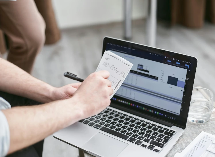 a man that is sitting in front of a laptop, a computer rendering, pexels contest winner, lined paper, no cropping, holding notebook, thumbnail