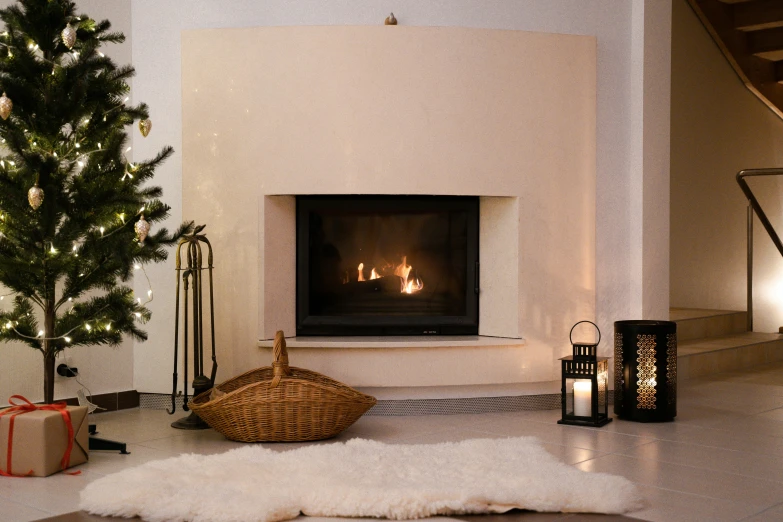 a christmas tree in a living room next to a fireplace, inspired by Riad Beyrouti, pexels contest winner, figuration libre, natural soft rim light, light brown fur, evening lighting, recessed