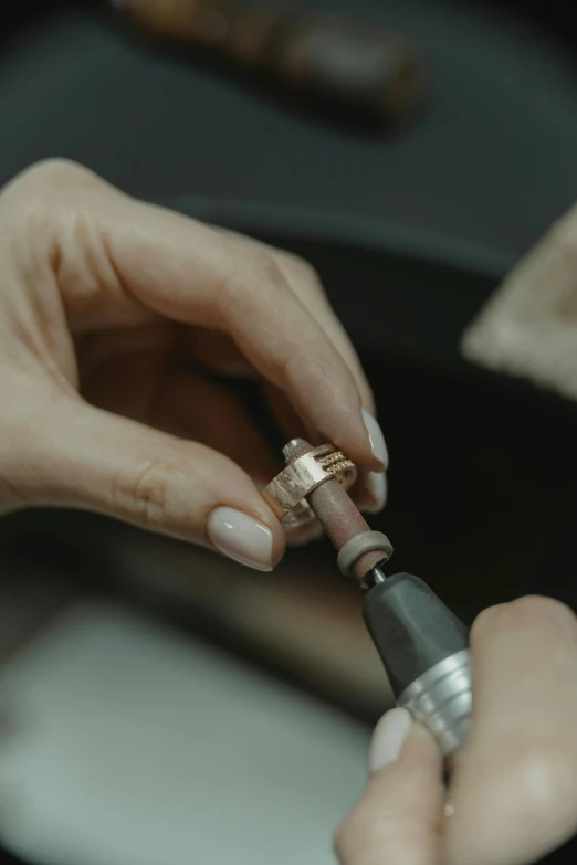 a close up of a person putting a ring on another person's finger, an engraving, by Ben Zoeller, instagram, smoking soldering iron, leica 8k still from an a24 film, van cleef & arpels, color graded