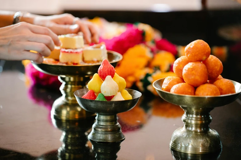 a close up of a plate of food on a table, shrines, candies, profile image, hinduism