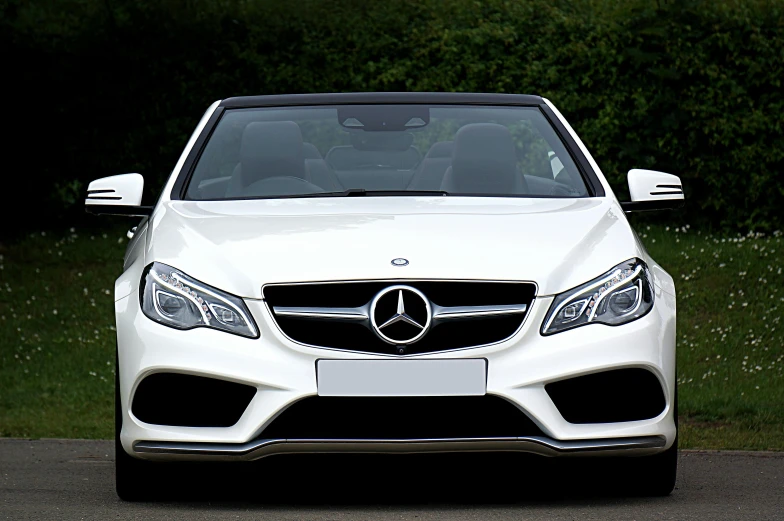a white car parked on the side of the road, mercedez benz, convertible, front of car angle, thumbnail