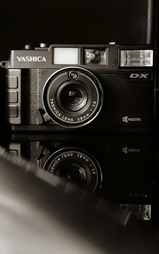 a black and white photo of a camera, a black and white photo, by Yasushi Sugiyama, nostalgic 8k, desaturated, high quality photo, cinematic outfit photo