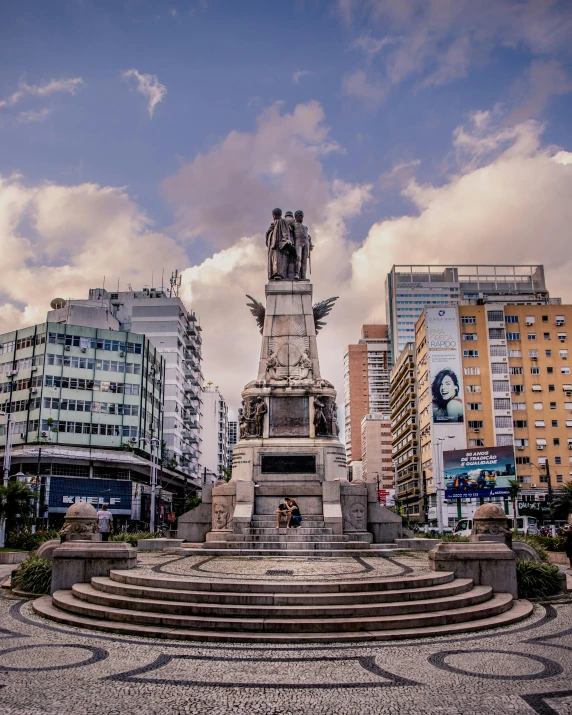a statue in the middle of a plaza surrounded by buildings, by Alejandro Obregón, unsplash contest winner, lgbtq, chilean, slide show, 🚿🗝📝