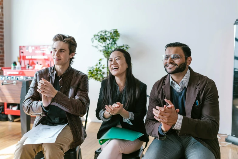 a group of people sitting next to each other, optimistic, performance, standing in class, wētā fx