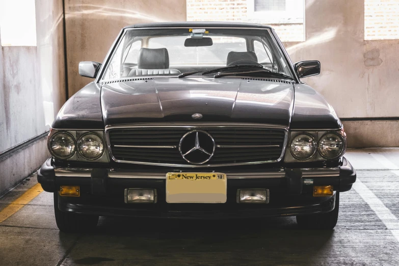 a car is parked in a parking garage, a portrait, unsplash, mercedez benz, 90s photo, extremely detailed + 8k, soft top