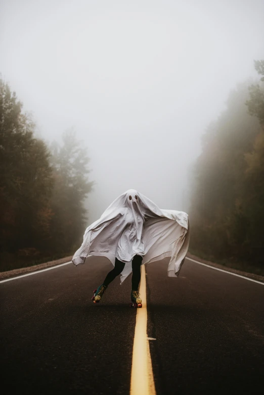 a person standing in the middle of a road covered in a sheet, inspired by Brooke Shaden, pexels contest winner, trick or treat, dressed a long white, grey, photo of a ghostly pirate