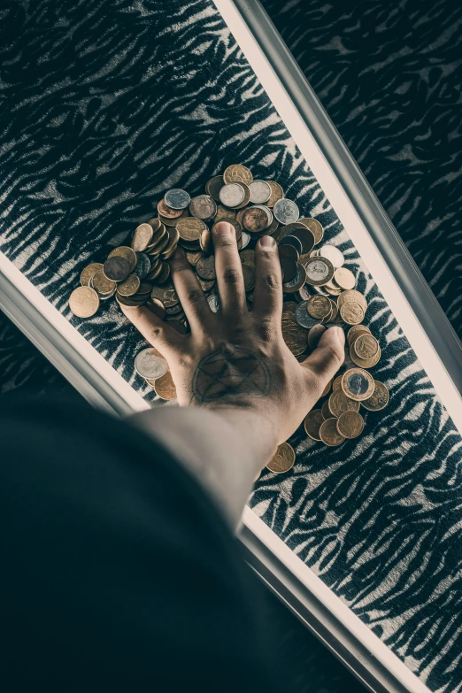 a person's hand reaching for a pile of coins, by Julia Pishtar, pexels contest winner, renaissance, trapped on a hedonic treadmill, in a hotel hallway, 5 0 0 px, made of money