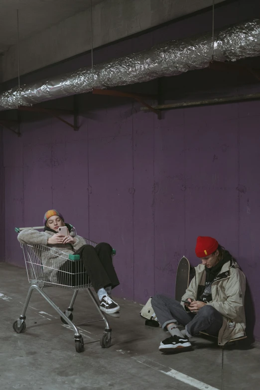 a couple of people sitting next to a shopping cart, trending on pexels, graffiti, wearing a purple cap, backrooms abandoned mall, heavy winter aesthetics, yung lean