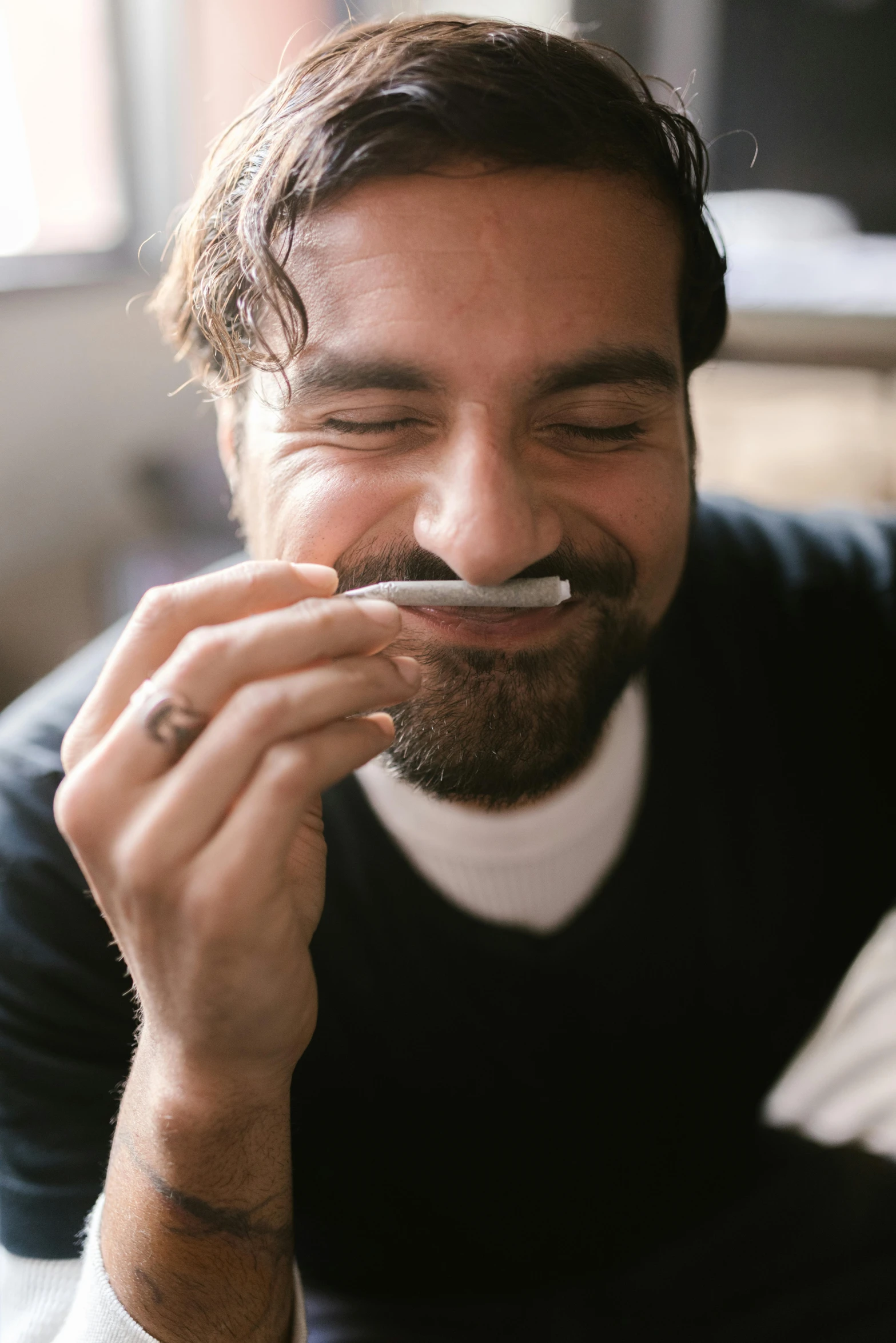 a man sitting on a bed with a spoon in his mouth, trending on reddit, mustache and soul patch, smoking a joint, smiling male, profile image