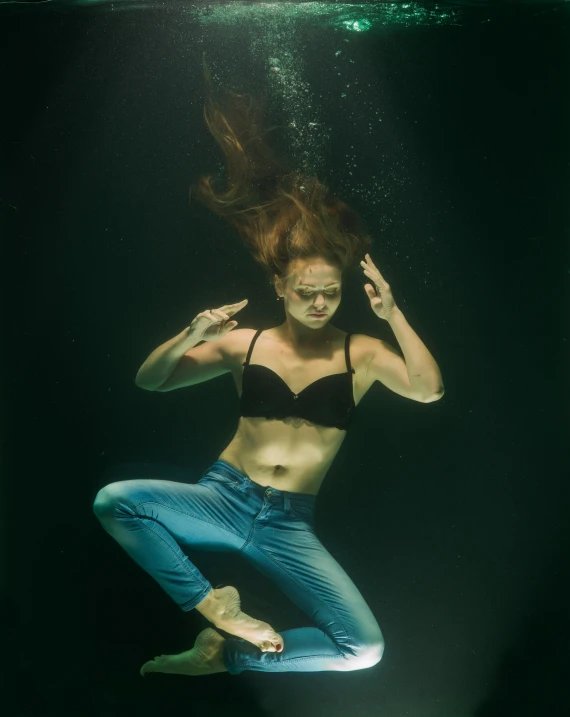 a woman in a bikini swims under water, inspired by Elsa Bleda, portait image