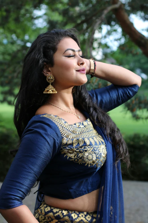 a woman in a blue sari posing for the camera, trending on cg society, curvy, earing a shirt laughing, profile image, large)}]