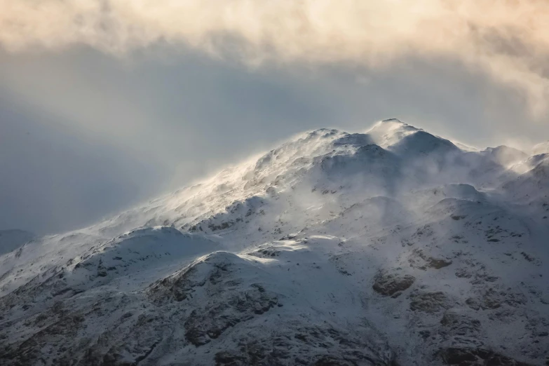 a mountain covered in snow under a cloudy sky, by Andrew Geddes, pexels contest winner, hurufiyya, light grey mist, iain mccaig, today\'s featured photograph 4k, brown