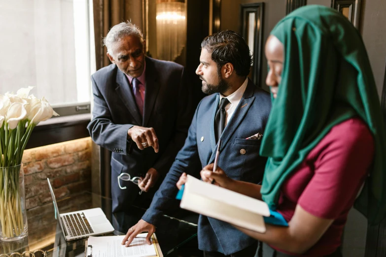 a group of people standing around a table with a laptop, pexels contest winner, hurufiyya, wearing robes and neckties, washington dc, malcolm hart, thorough details