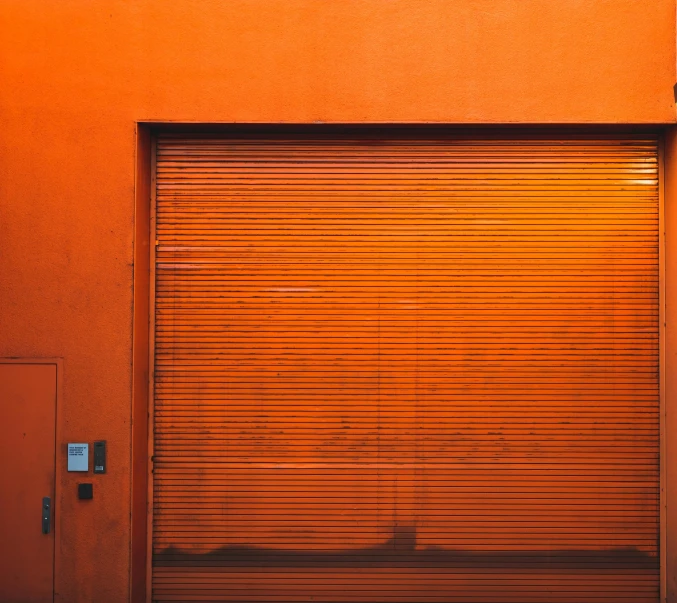 a fire hydrant in front of an orange building, a minimalist painting, pexels contest winner, doors, metal shutter, [[empty warehouse]] background, conor walton