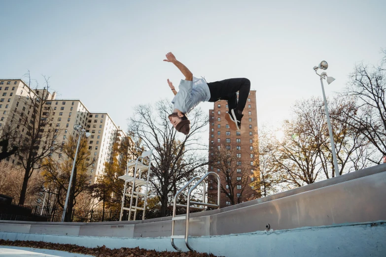 a man flying through the air while riding a skateboard, by Niko Henrichon, unsplash contest winner, graffiti, parkour, neo kyiv, low quality footage, fall season