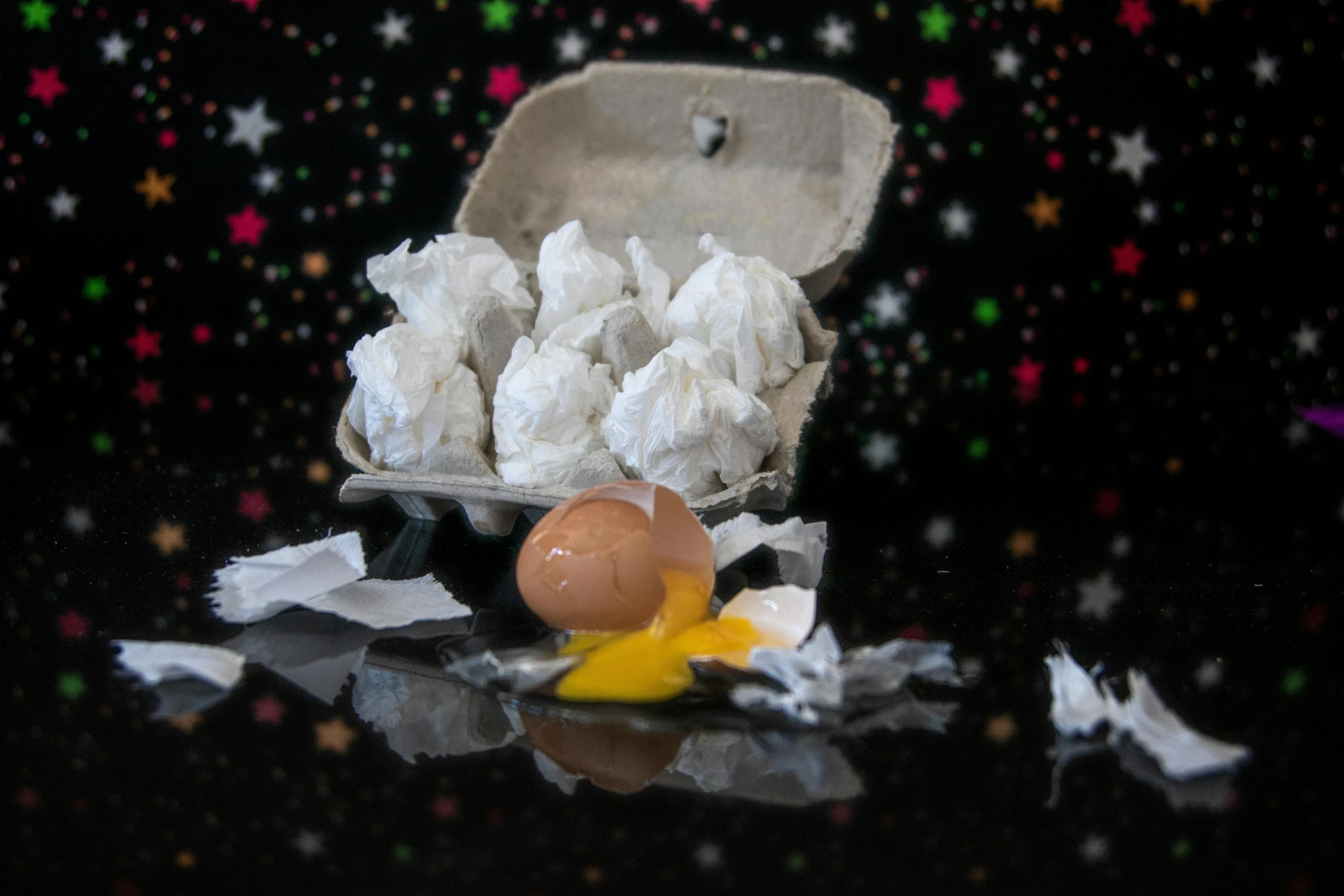 a box of eggs sitting on top of a table, a still life, by Lee Loughridge, happening, meteorites, spectacular quality torn paper, miniature product photo, snining stars