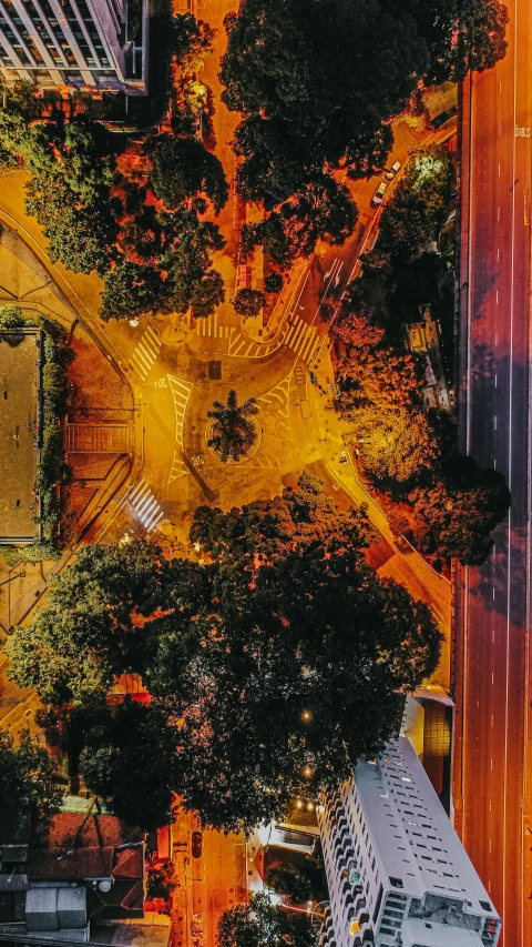 an aerial view of a city at night, an album cover, unsplash contest winner, in a city park, são paulo, yellow and ornage color scheme, unsplash 4k