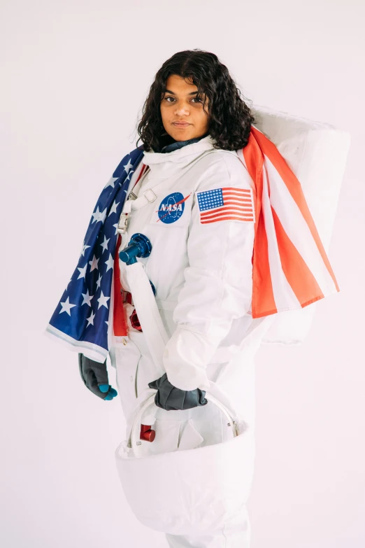 a woman in an astronaut suit holding an american flag, promotional photoshoot, ameera al taweel, - 9, costume