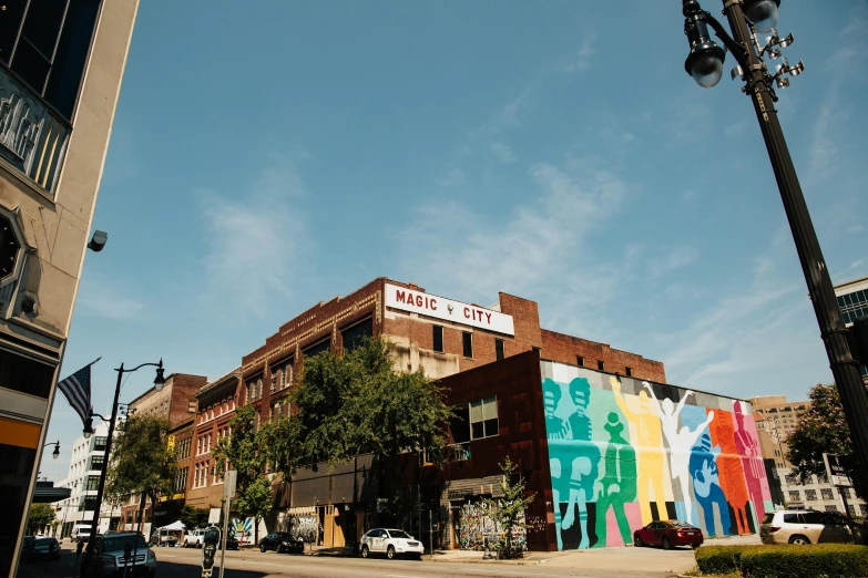 a building with a mural on the side of it, by Carey Morris, pexels contest winner, brick building, city views, marc newsom, thumbnail