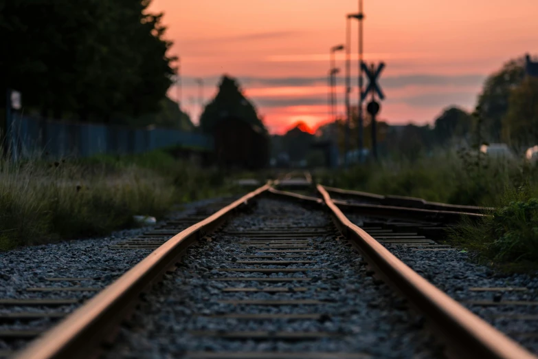 a train track with a sunset in the background, pexels contest winner, realism, rectangle, instagram post, late summer evening, multiple stories