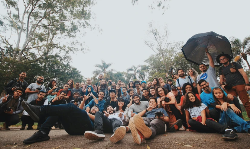 a group of people posing for a picture with an umbrella, by Alejandro Obregón, pexels contest winner, happening, weta studio and james jean, piled around, panorama shot, a portrait of rahul kohli