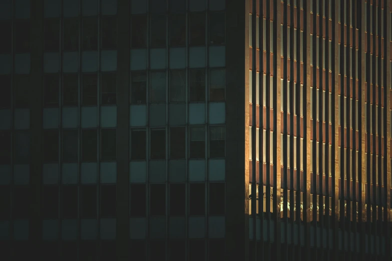 a couple of tall buildings next to each other, by Tobias Stimmer, pexels contest winner, modernism, dramatic backlit window, reflections in copper, square lines, telephoto shot