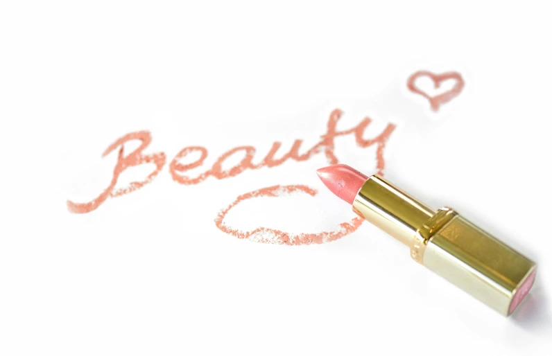 a lipstick with the word beauty written on it, peach embellishment, loosely drawn, uploaded, on white background