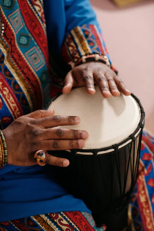 a close up of a person holding a drum, african ameera al taweel, multiple stories, stockphoto, emmanuel shiru