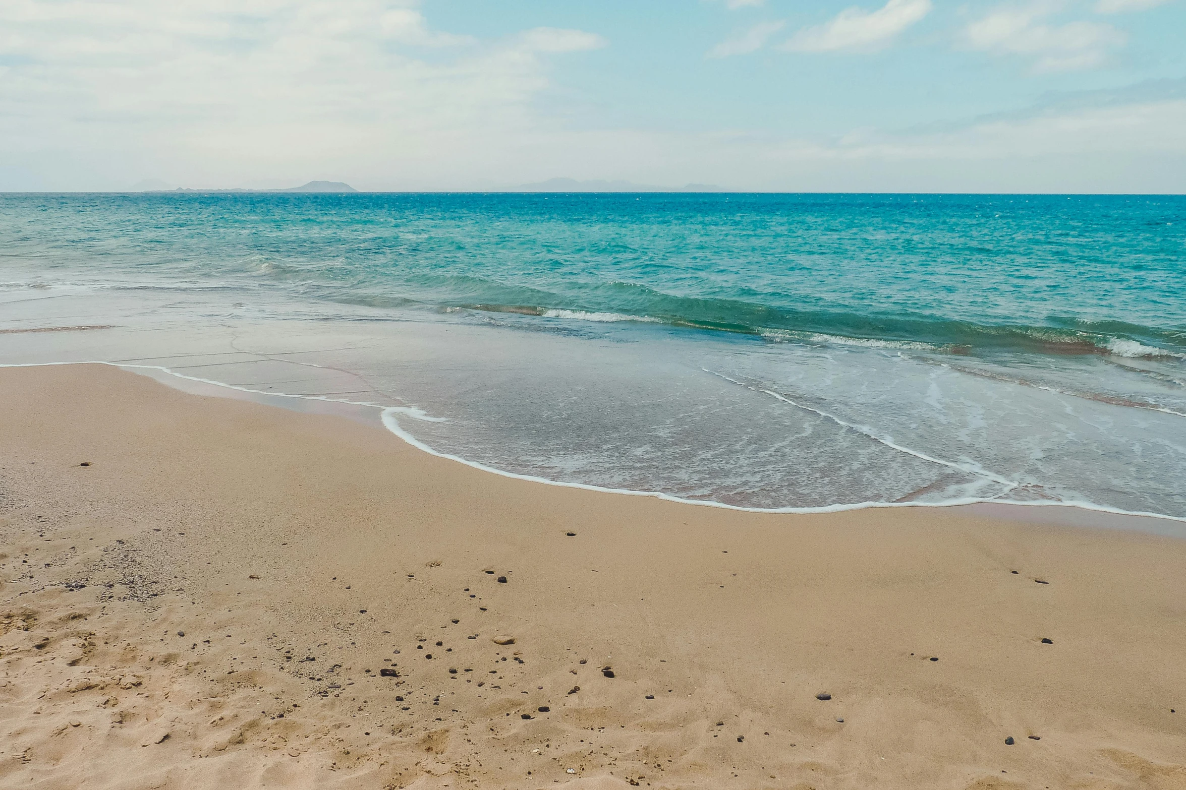 a large body of water sitting on top of a sandy beach, by Nina Hamnett, pexels contest winner, azores, marbella, hd footage, clean image