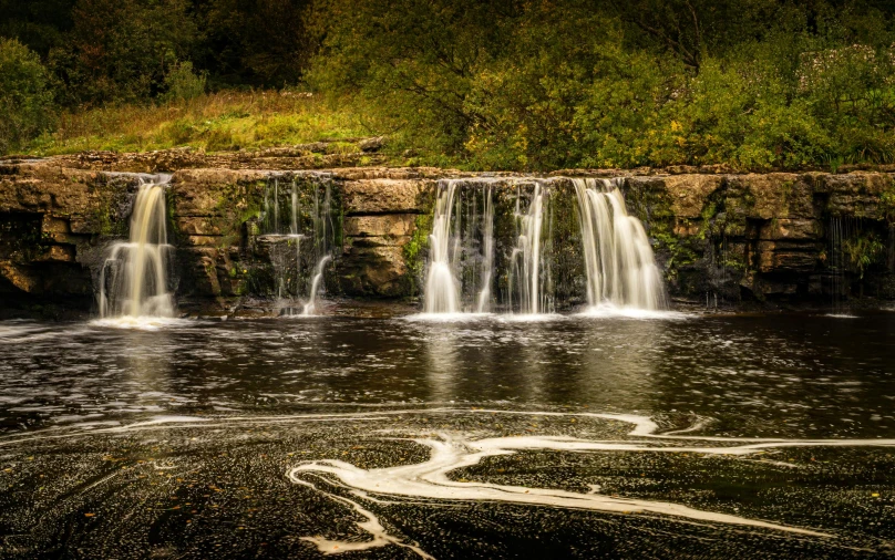 a waterfall in the middle of a body of water, by Andrew Allan, pexels contest winner, romanticism, paisley, sandfalls, well preserved, 2 0 0 0's photo