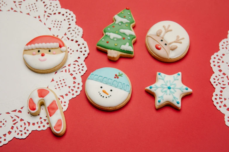 a table topped with christmas cookies and decorated cookies, a stipple, by Julia Pishtar, pexels, on a red background, enamel, 15081959 21121991 01012000 4k, thumbnail