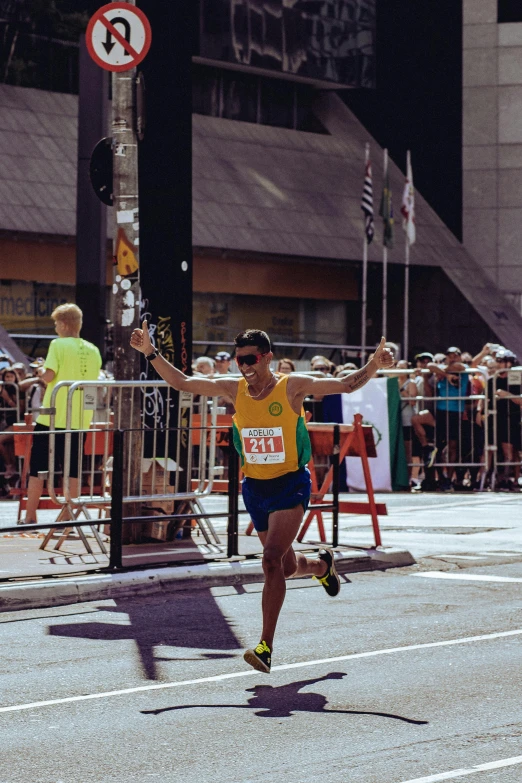 a man that is running in a race, pexels contest winner, with arms up, yellow aureole, leslie zhang, 🚿🗝📝