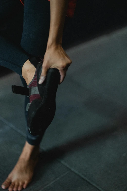 a close up of a person tying up a pair of shoes, by Jan Tengnagel, trending on unsplash, athletic crossfit build, panorama, pulling the move'derp banshee ', pointe pose