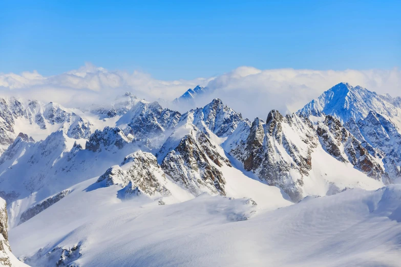 a group of people riding skis on top of a snow covered slope, craggy mountains, avatar image