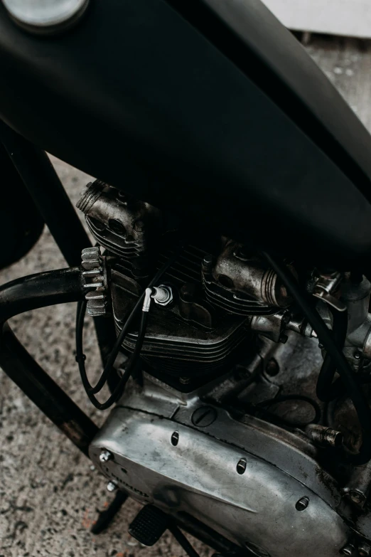 a close up of a motorcycle parked on a street, by IAN SPRIGGS, unsplash, closeup of car engine, hoses:10, low quality photo, grey metal body