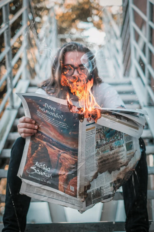 a man sitting on a set of stairs reading a newspaper, by Sebastian Spreng, pexels contest winner, all face covered with a fire, her hair is made out of fire, science magazine cover, al fresco