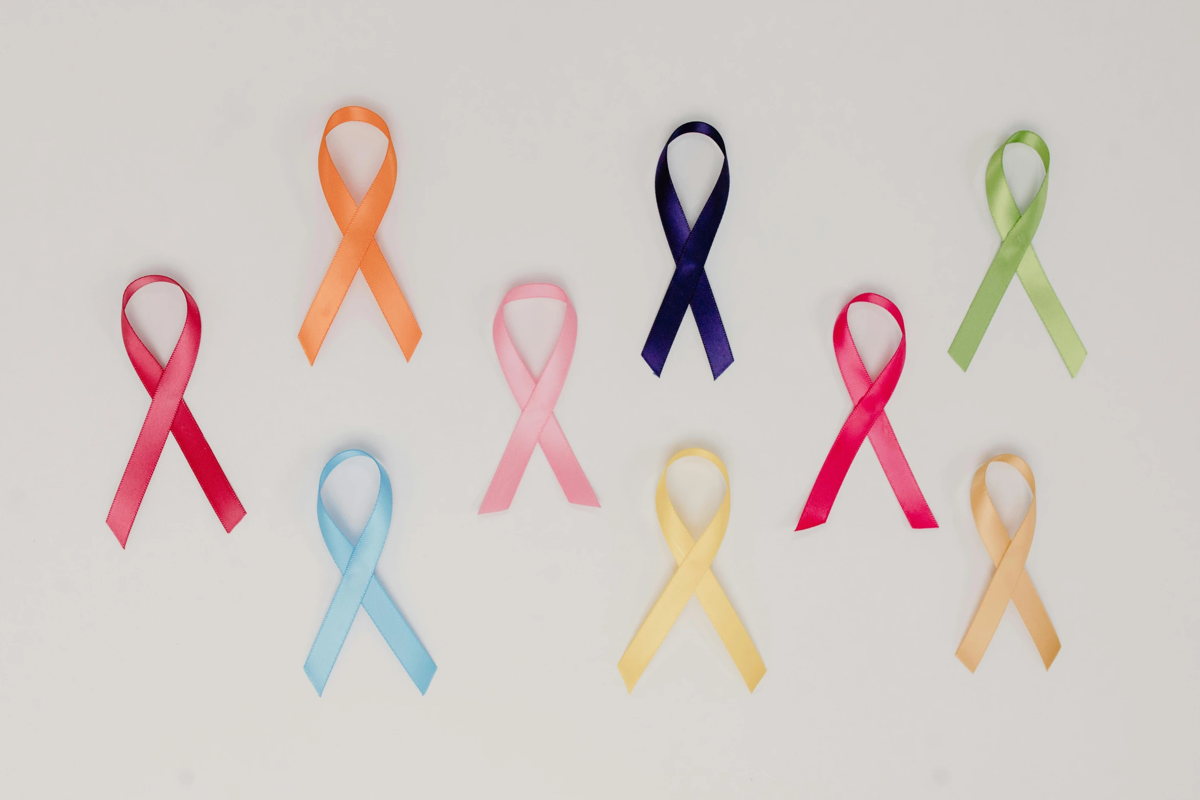 a number of different colored ribbons on a white surface, a cartoon, pexels, antipodeans, the cure for cancer, profile image, nursing, full body image