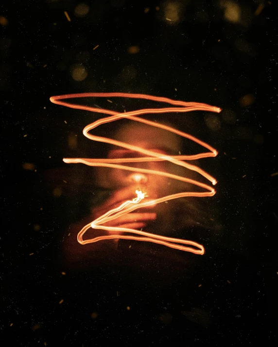 a close up of a light in the dark, an album cover, pexels, light and space, cyber copper spiral decorations, firey, light scatter, red and yellow light