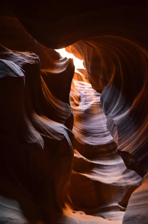 the light shines through a narrow slot in a canyon, an abstract sculpture, by Jessie Algie, pexels contest winner, devils horns, brown, swirls, a handsome