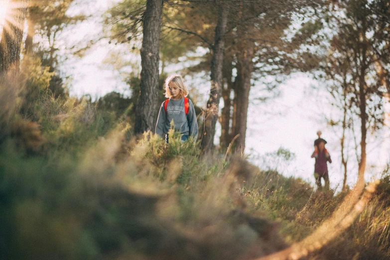 a couple of people walking through a forest, unsplash, kids playing, arrendajo in avila pinewood, avatar image, girl walking on mountain