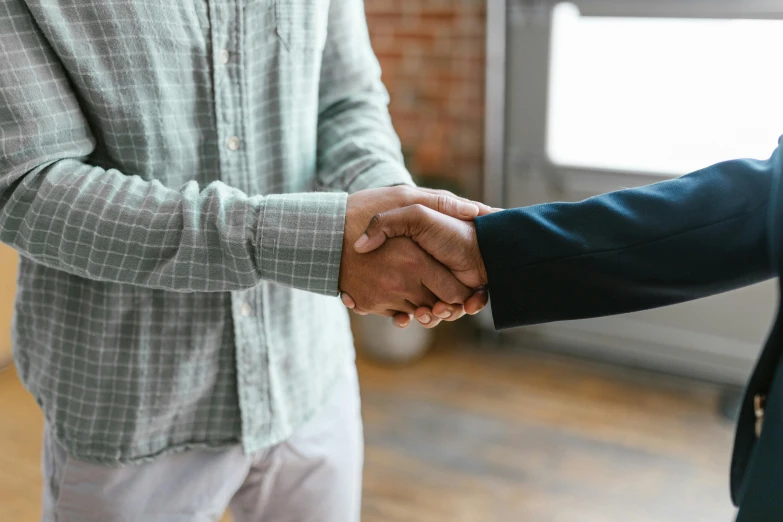 a close up of two people shaking hands, pexels contest winner, private press, background image, casually dressed, matthew williams, various posed